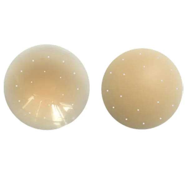 Two beige silicone balls with small holes on a white background