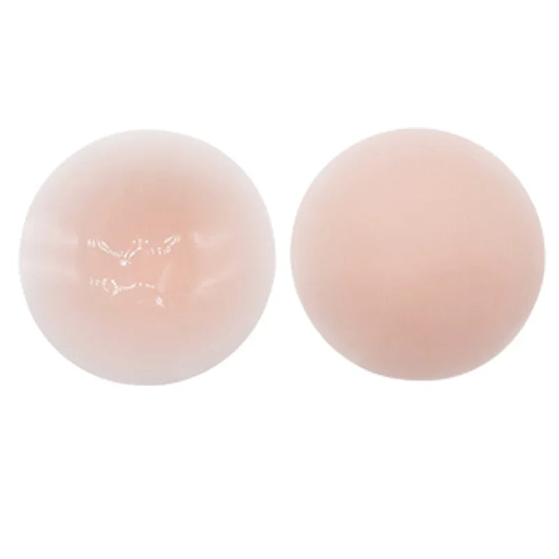 Two round, pink silicone pads on a white background with text.
